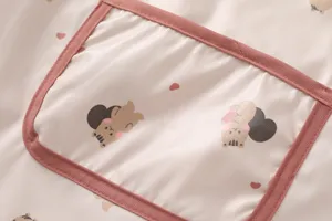 Cute waterproof baby bib detail shot with adorable bear print and pink pocket design.
