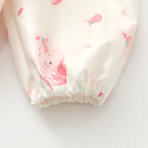 Waterproof children art smock sleeve detail, cute pink bunny strawberry print design cuff.