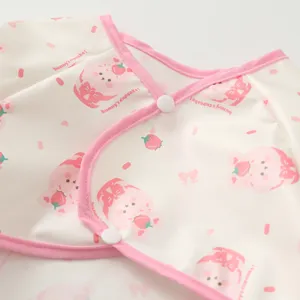 Close up detail of baby waterproof long sleeve art smock bib with cute pink bunny pattern.