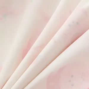Close-up of pink waterproof fabric with cute print, ideal for kids art smock detail view.