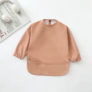 Vista detallada del babero de manga larga impermeable para bebé con diseño plano y bolsillo.