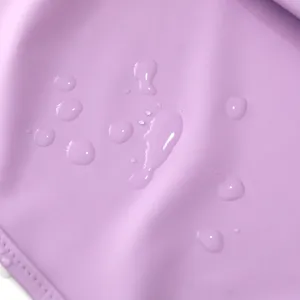 Waterproof fabric detail of baby bib, light purple color, liquid repellent surface design.