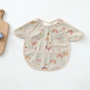 Detailed view of waterproof baby bib with cute rainbow and cloud pattern, soft PU fabric.