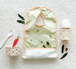 Detailed view of baby waterproof bib featuring cute olive print, soft material for feeding time.