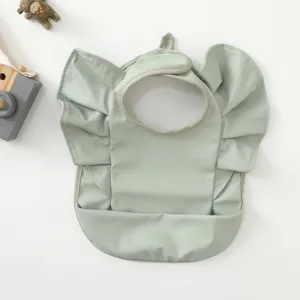 Waterproof baby bib with cute angel wings and crumb catcher pocket, minimalist light green design.