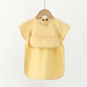 Waterproof baby bib with short sleeves, soft PU material and front pocket for easy feeding time.