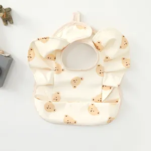 Waterproof baby bib with cute bear print and ruffles, ideal for feeding and daily use.