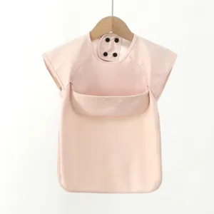 Detailed view of waterproof baby PU bib, short sleeve feeding coverall in soft pink color.