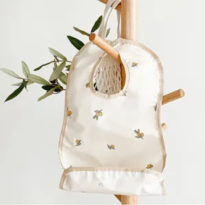 Waterproof baby bib with cute olive print, lightweight and easy to clean for toddlers feeding time.
