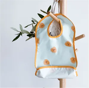 Baby waterproof feeding bib detail, cute animal print with orange trim and handy pocket.