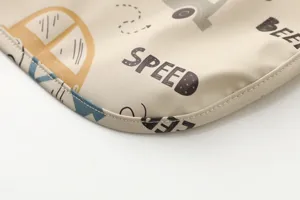 Waterproof baby bib detail, soft PU feeding cover with cute cars print, durable baby accessory.