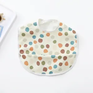 Waterproof baby bib with cute polka dot pattern, soft PU toddler feeding bib for daily use.