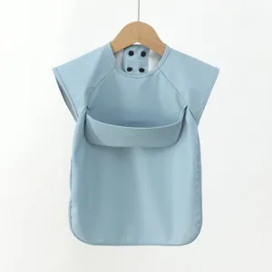 Detailed view of the blue baby bib showing waterproof PU fabric and convenient front crumb pocket.