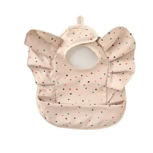 Waterproof baby bib with cute angel wings and polka dots, ideal for infant feeding time.