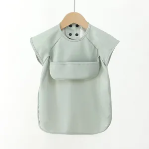 Baby waterproof PU short-sleeve bib, solid light green color, snap button closure, detail view.