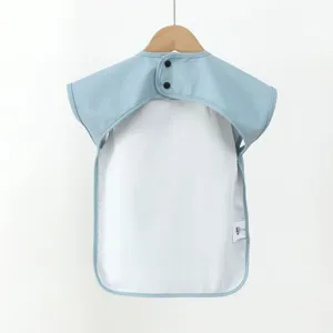 Baby waterproof dining bib detail view, soft short sleeve smock for infant feeding.