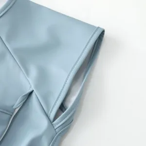 Detailed view of baby waterproof PU short sleeve bib sleeve seam and soft fabric texture.