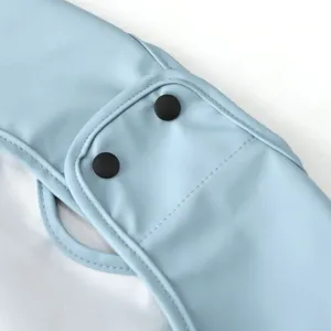 Close-up detail of toddler PU waterproof short-sleeve bib featuring black snap button closure.