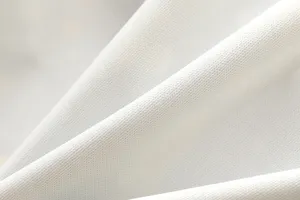 Nahaufnahme der Textur von weißem atmungsaktiven Stoff mit weichen Falten und feinem Netz.