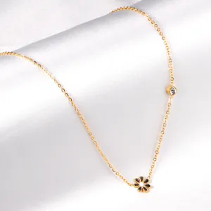Gold stainless steel chain necklace with enamel daisy flower pendant and sparkling crystal.