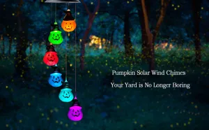 Multicolor solar pumpkin wind chimes with witch hats illuminating a dark night garden