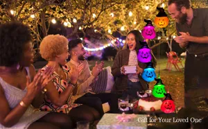 Solar Halloween pumpkin wind chime lights illuminating an outdoor night party family gathering