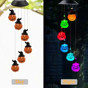 Solar powered Halloween pumpkin wind chimes with color changing LED lights for garden decor.