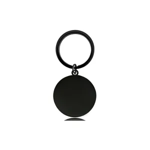Detailed close-up view of a minimalist matte black stainless steel round blank keychain pendant