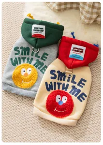Close-up detail of cute pet hoodie featuring soft fleece material, cute cartoon patch and comfortable hood.