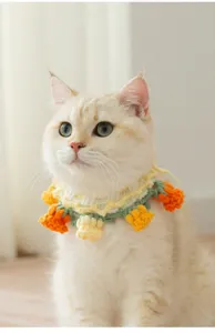 Cute handmade crochet tulip cat collar pet bib detail shot, soft yarn woven floral accessory.