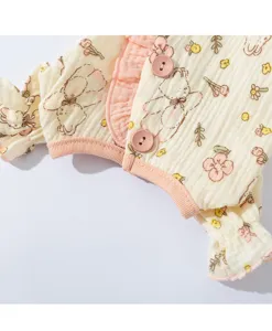 Vista detallada de ropa para mascotas con lindo estampado de osito y botones.