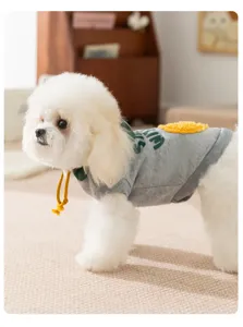 Cute pet hoodie detail showing soft gray fabric, green print and yellow fuzzy ball decor.