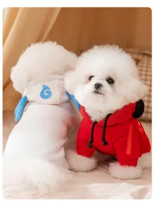 Detailed shot of cute small dogs wearing warm fleece hoodies with cute design for winter season.