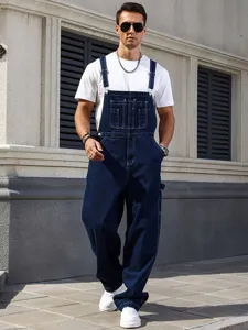 Detailed view of men baggy denim overalls in dark blue, casual high street streetwear.