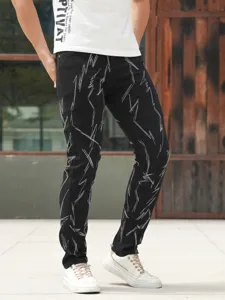 Detailed view of men's slim-fit stretch denim jeans featuring unique heavy white embroidery.