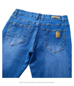 Men's blue slim fit denim jeans detail view with classic pockets and stylish back patch.