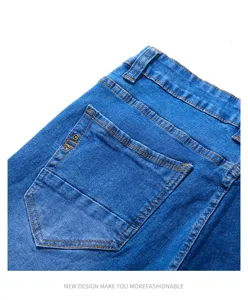 Men's blue slim fit denim jeans back pocket and waistband detail closeup showcasing neat stitching.