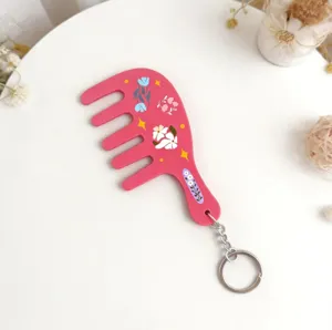 Pink floral comb keychain detail shot, cute resin comb pendant with metal keyring and flowers.
