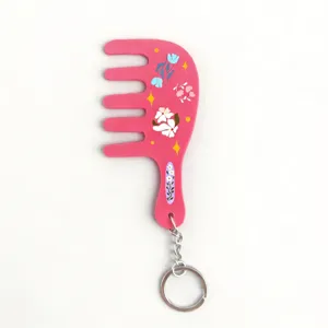 Pink comb shaped keychain with cute floral and star prints, detailed view accessory charm.