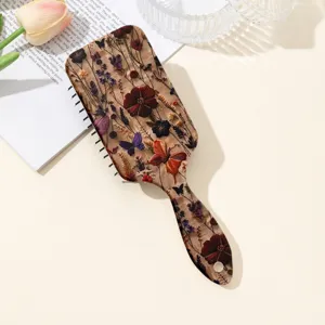 Brosse à cheveux coussin d'air florale vintage avec motif papillon pour massage et démêlage.