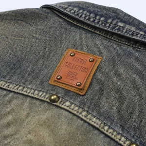 Vintage washed denim sleeveless vest back detail, distressed retro style men's casual outerwear.