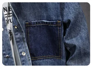 Close-up detail of men's retro denim shirt showing contrast pocket and metal buttons.