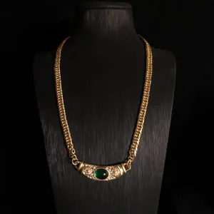 Vintage gold plated copper chain necklace featuring a green glass stone and delicate rhinestones.