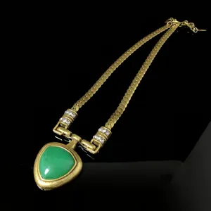 Vintage gold-toned necklace with green triangular pendant and rhinestone details for women