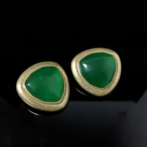 Vintage style geometric triangular earrings with green center and gold-toned metal frame.
