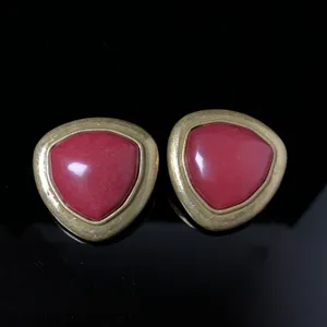 Vintage style triangle red stone earrings detailed close-up shot, retro gold tone jewelry piece.