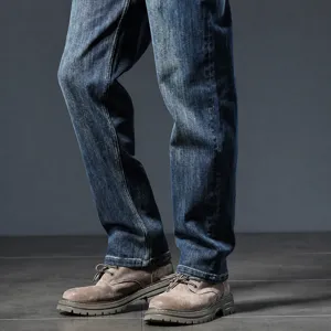 Classic men's blue denim jeans paired with stylish casual boots for a versatile retro look.