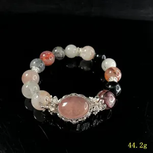Crystal beaded bracelet detail view with mixed gemstone beads and silver accessory