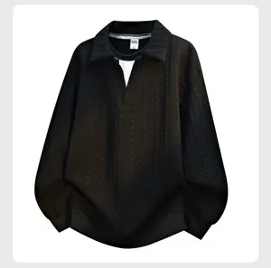 Detailed view of the black fake two-piece polo sweater, textured knit fabric design.