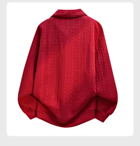 Detailed view of red knit lapel sweatshirt showing fine texture and cozy fabric close up.